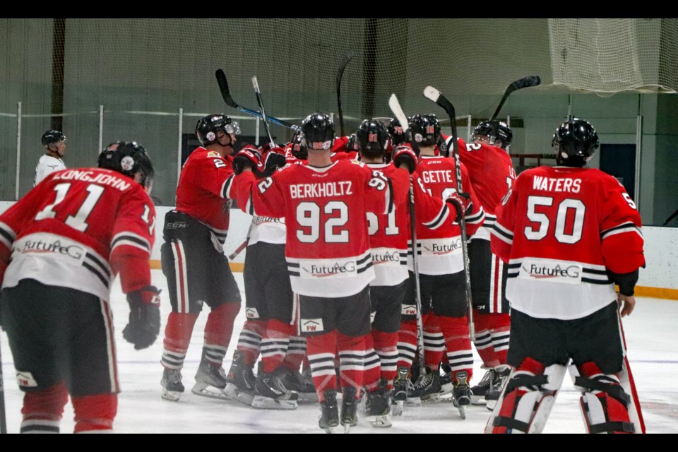 The Innisfail Eagles swarm assistant captain Ty Clay after he scored the winning goal in the second overtime period in Game 2 of the North Central Hockey league semifinals on Feb. 23 at the Innisfail Twin Arena. The best of five series is now tied at one game apiece. Johnnie Bachusky/MVP Staff