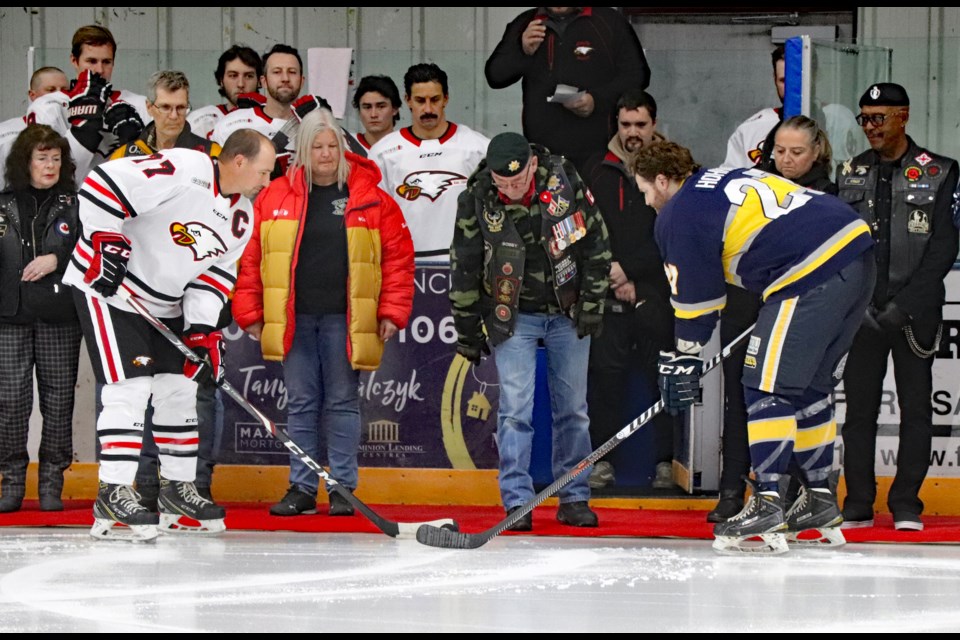 Canadian Army veteran Robert Crites, centre-right, drops the ceremonial puck for Veterans Appreciation Night on Nov. 4 at the Innisfail Twin Arena before the hockey game between the Innisfail Eagles and Stony Plain Eagles. 
Johnnie Bachusky/MVP Staff