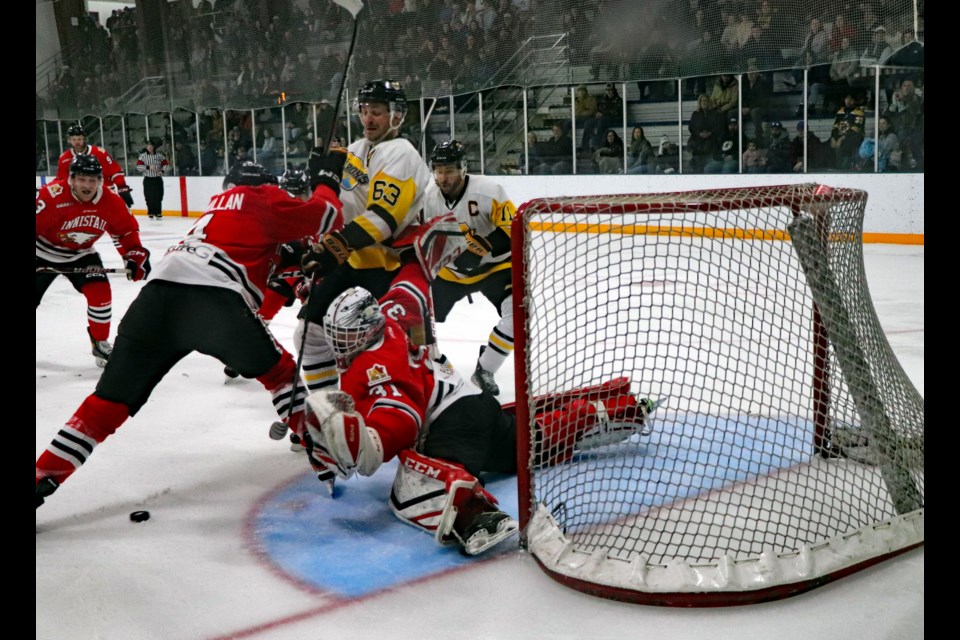 Furious third period action by the Devon Barons around Innisfail goalie Chance Griffith who faced 34 shots to claim the 4 - 3 win for the Eagles on Feb. 16 at the Innisfail Twin Arena. Johnnie Bachusky/MVP Staff