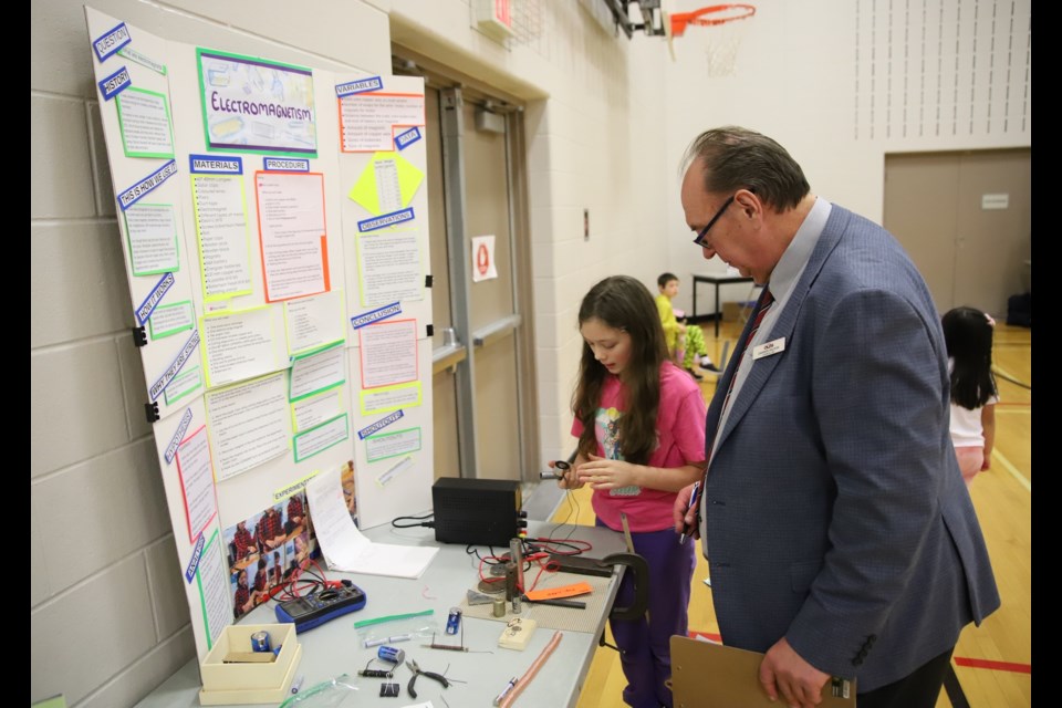 Grade 5 Holy Trinity Catholic School student Jessica Gardner explains her elelctromagnetism project to Deputy Mayor Darren Wilson.
Doug Collie/MVP Staff