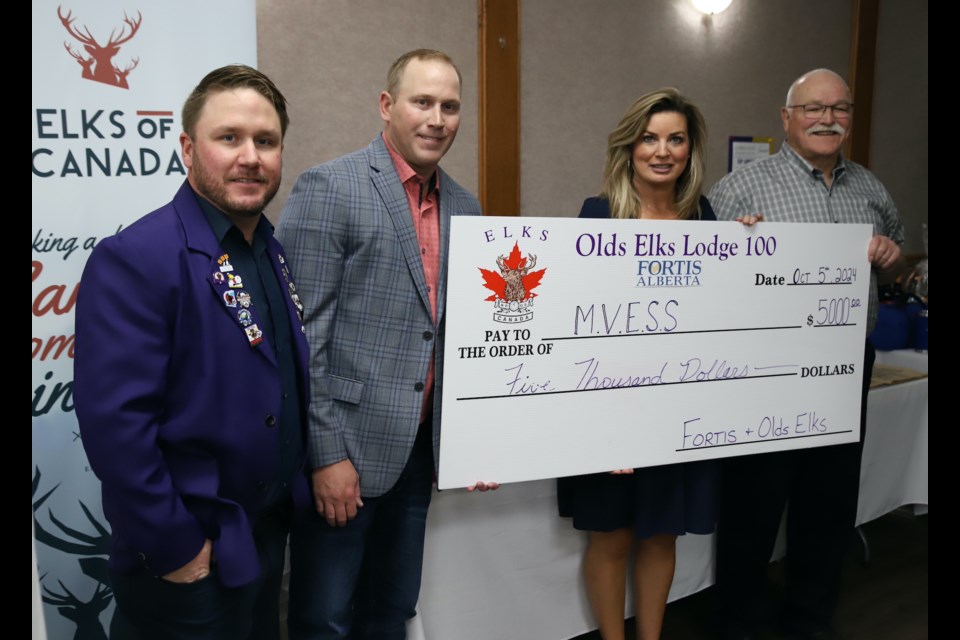 A cheque for $5,000 for the Mountain View Emergency Shelter Society (MVESS), the result of a contribution by FortisAlberta and matched by the Olds Elks Club was unveiled during the club’s 100th anniversary celebrations in the Royal Canadian Legion Branch 105 on Oct. 5. From left are Jason McBeath of the Olds Elks, Dan Leatherdale of FortisAlberta, MVESS fundraising committee director Dale Rosehill and MVESS president Joe Carignan.
Doug Collie/MVP Staff