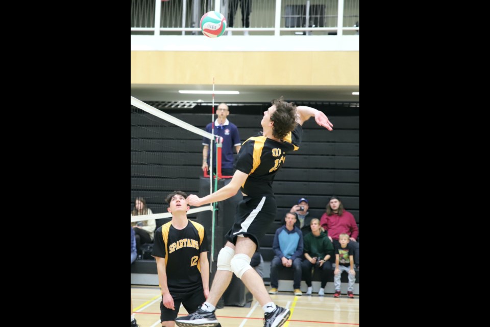 Liam Morgan (13) gets ready to spike the ball as teammate Ethan Giesbrecht looks on during the senior boys and senior girls home volleyball tournament, held Oct. 13 and 14 at the CLC Gym. 