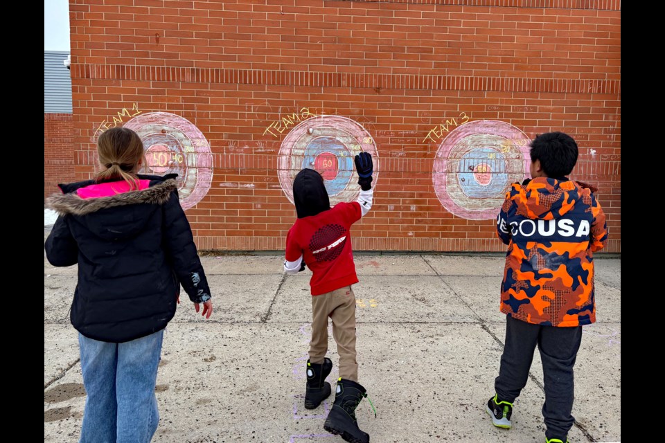 Young students at St. Marguerite Bourgeoys Catholic School have fun at a snowball target game, as well as several other activities, following a spaghetti lunch for the St. Marguerite Feast Day Celebration on Jan. 10. Johnnie Bachusky/MVP Staff