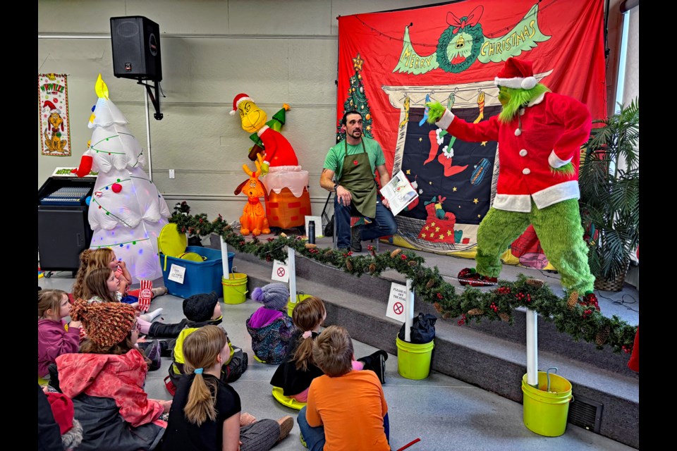 Storybook Corner presenter Kyle Letourneau appears startled by the Grinch during his reading to children of How the Grinch Stole Christmas! at the 5th Annual Innisfail Grinchmas. The event was held on Saturday, Nov. 30 from noon to 4 p.m. at the Innisfail United Church. Johnnie Bachusky/MVP Staff