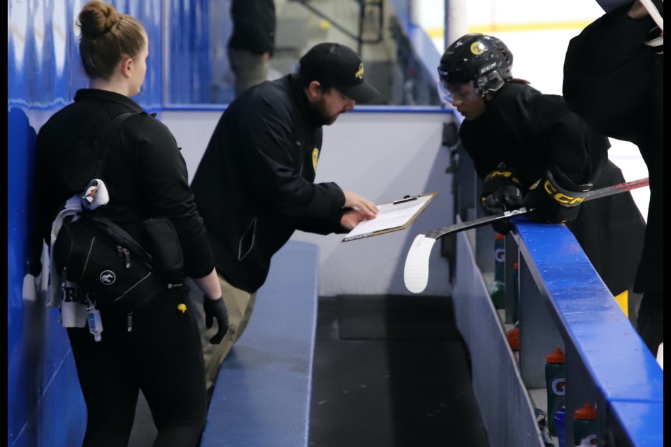 Olds Grizzlys head coach Brad Tobin guides a player just before the team’s Black and Gold game took place Aug. 25. 
Doug Collie/MVP Staff