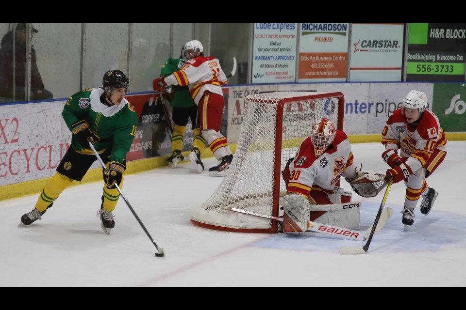 Calgary Canuck goaltender Cruz Chase and forward Jack Plandowski defend the net as Grizzlys forward Connor Seeley, the club's captain, looks for a teammate to pass to.
Doug Collie/MVP Staff