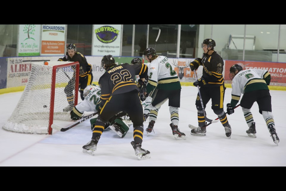 The puck slides behind Okotoks Oilers goaltender Alex Scheiwiller during a Dec. 16 game between the Olds Grizzlys and the Okotoks Oilers in the Olds Sportsplex. The Oilers went on to win 3-1.