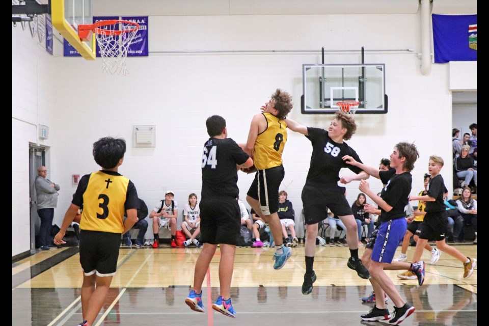 The St. Marguerite boys team drives hard to score during their thrilling come from behind playoff game against Leslieville’s David Thompson High School at the  4th annual Growler Basketball Tournament on Jan. 25.