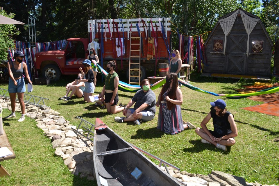 Director Sabrina Naz Comanescu, far left, works out a scene with the cast of the musical Hair, now being presented at the Mascke farm just north of Olds. Former Olds aea resident Ryan Maschke (in green shirt) can be seen fifth from the left among the cast.
Doug Collie/MVP Staff