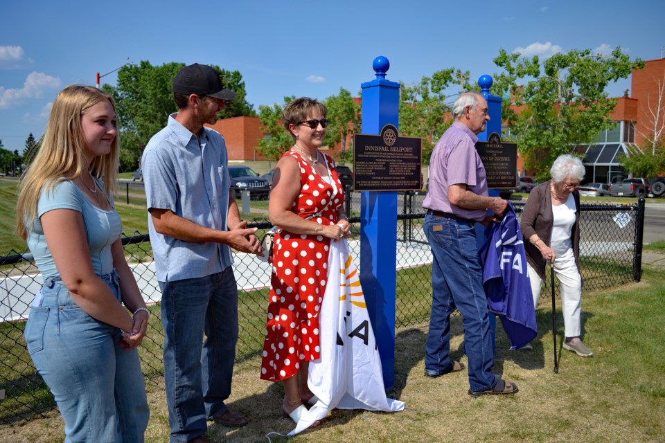 Representatives from the Rotary Club of Innisfail and the Kneehill Valley 4-H Beef Club, as well as former Innisfail mayor Pat Newman (far right) on behalf of her late husband Bob, remove the covers off the new plaques for the upgraded Innisfail Heliport during the facility's grand opening on June 8. Johnnie Bachusky/MVP Staff
