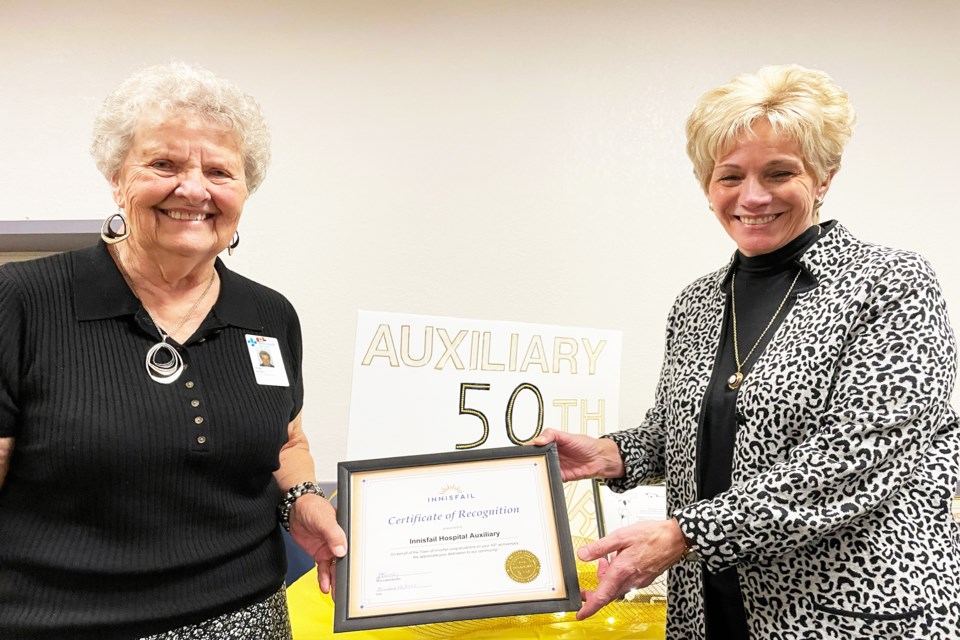 Rose Winters, president of the Innisfail Health Centre Auxiliary (left), left accepts a Certificate of Recognition from mayor Jean Barclay at the 50th anniversary celebration for the local volunteer group on Oct. 28 at the Innisfail Royal Canadian Legion Branch #104. Johnnie Bachusky/MVP Staff