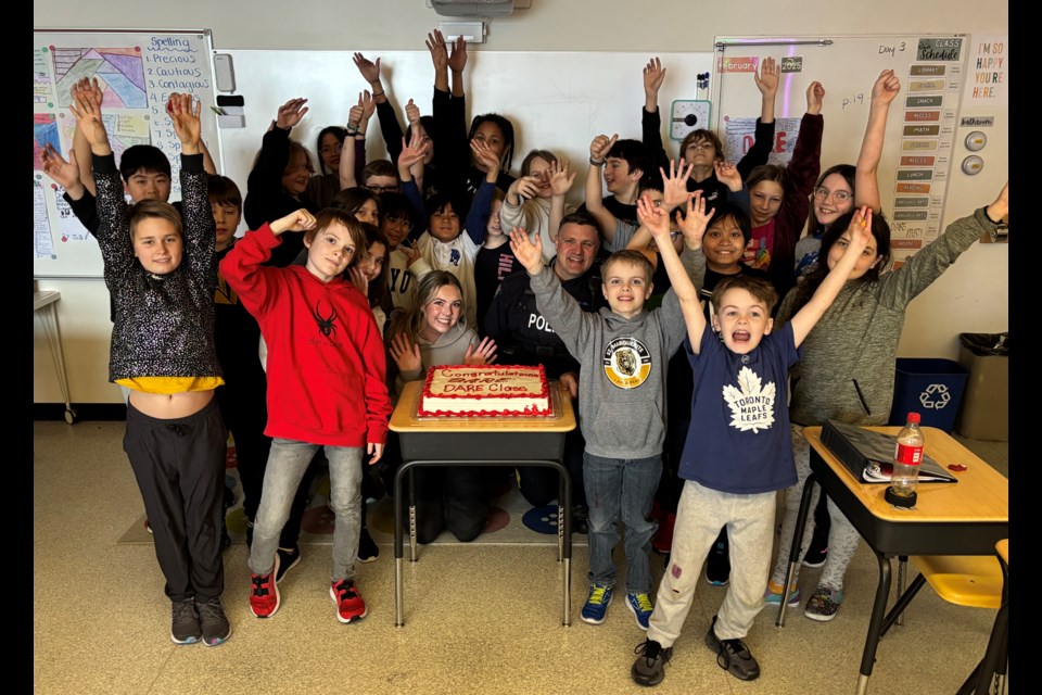 The 28 Grade 5 students at St. Marguerite Bourgeoys Catholic School celebrate their graduation with cake from their 10-week D.A.R.E. program. Each student also received a certificate. Johnnie Bachusky/MVP Staff 