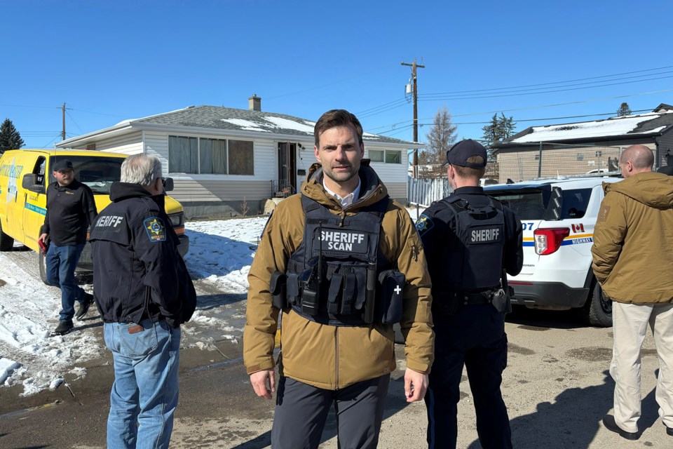 SCAN manager Mike Dirkson in front of a boarded up house at 4127 49A Avenue in Innisfail on Tuesday, March 11.