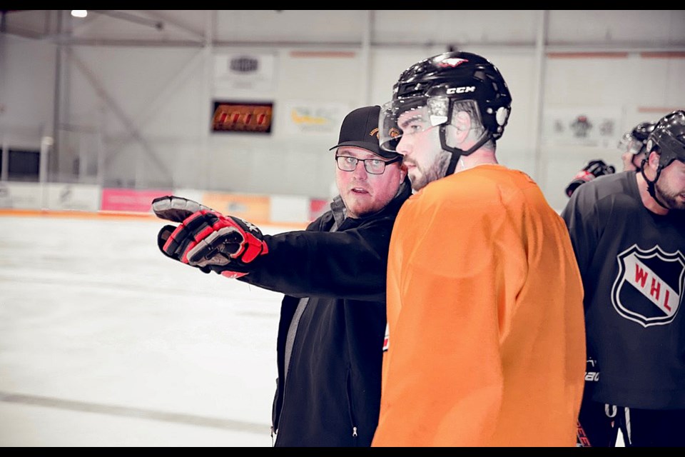 Ryan Dodd, general manager and co-head coach of the Innisfail Eagles, left, offers some direction to a team player at a recent pre-season practice in Olds. 
Doug Collie/MVP Staff