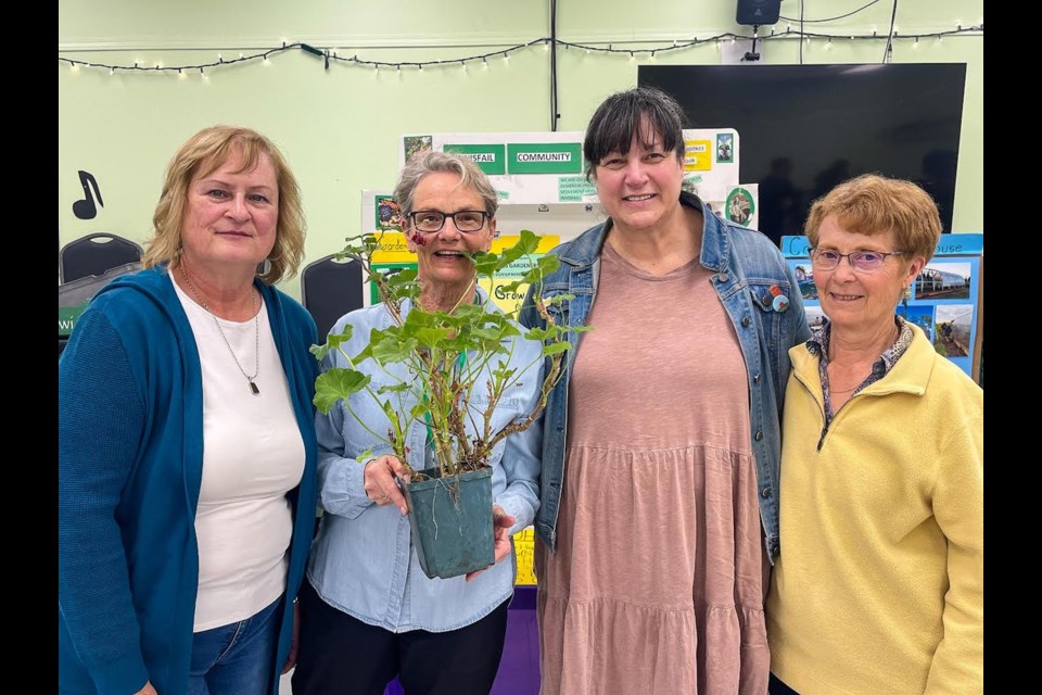 Members of the Innisfail & District Garden Club and local citizens gathered at the Lundgren Centre on April 7 for the first Spring into Gardening event to raise awareness of the club and gardening. From left to right is Grace Baxter, Pauline Wigg, local artist Karen Scarlett and Marion Davidson, manager of the Innisfail Community Garden. Photo by Candice Hughes