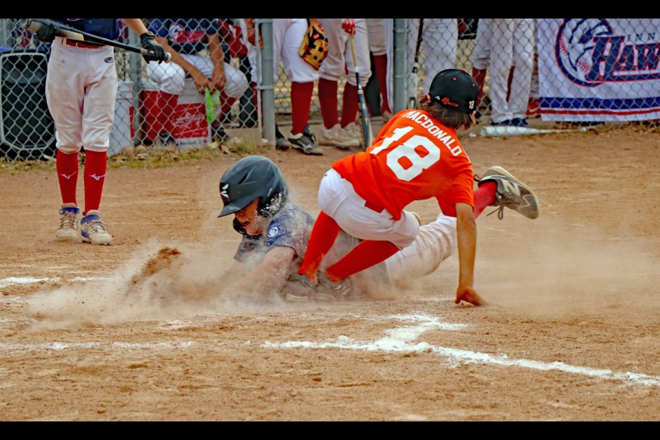 Innisfail Hawks' Cash Miller slides safe into home plate to put his team on the board against the Cochrane Crush on Aug. 3 during the 2024 13UAA Tier 3 Provincials tourney in Innisfail. The Hawks went on to win the game 19 - 9. Johnnie Bachusky/MVP Staff