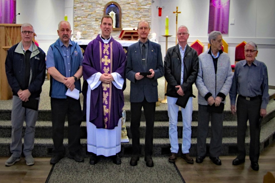 Long-time members of Innisfail Council 7203 of the Knights of Columbus line up in March to receive certificates for their longstanding service to Innisfail's Our Lady of Peace Catholic Church. From left to right are Denis Hendrick (31 years), Pat Spiller, grand knight, Father Curtis Berube, Cliff Cawley (38 years), Dan Boyd (41 years), John Ferris (45 years) and Bill Mack (66 years). Members unable to attend the ceremonies include Terry Hayden (32 years), Wayne Schaab (31 years) and Blaine Staples (25 years). Photo by Art Gordon