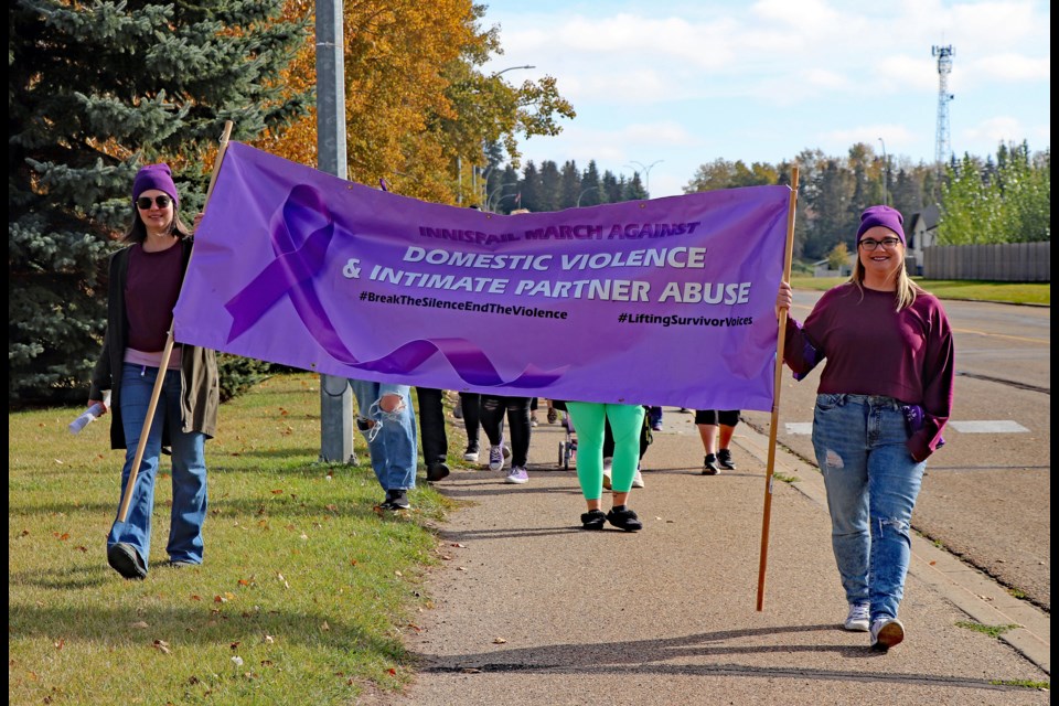 Organizers Lisa Robinson, left, and Erika Fetterly lead supporters of the 3rd annual Innisfail March Against Domestic Violence and Intimate Partner Abuse from Legion Park and then down Cemetery Hill to Centennial Park on Oct. 1.  
Johnnie Bachusky/MVP Staff