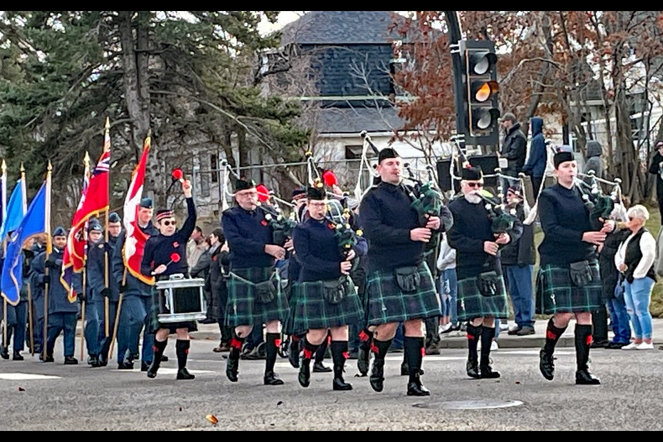 INNISFAIL REMEMBERS - The Innisfail Legion Pipe Band leads the colour guard at the start of Innisfail's 2023 Remembrance Day ceremony at the downtown cenotaph. Johnnie Bachusky/MVP Staff