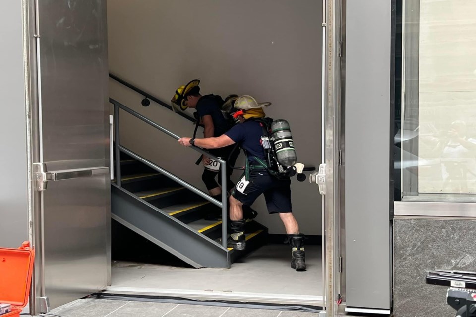 Innisfail firefighters in action on June 11 climbing the stairs of the 247-metre tall Brookfield Place, Calgary's tallest tower. The Innisfail team of four firefighting heroes raised $3,500 this year for Wellspring Calgary. Facebook photo