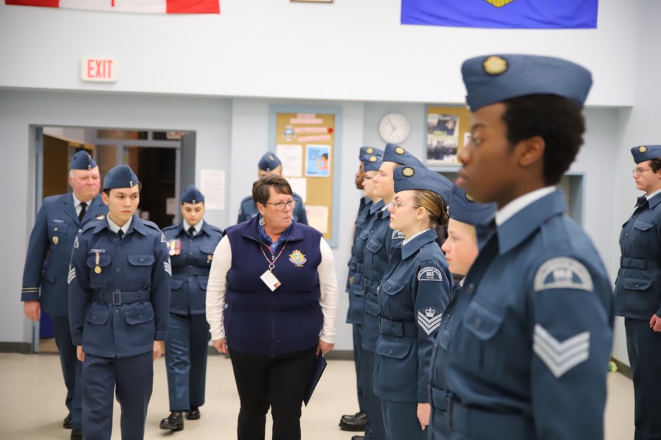 Rhonda Barraclough, centre, chair of the Alberta provincial committee of the Air Cadet League of Alberta, inspects members of the Royal Canadian Air Cadets Squadron No. 185 during a ceremony Feb. 2 at the Air Cadet Hall in Olds.