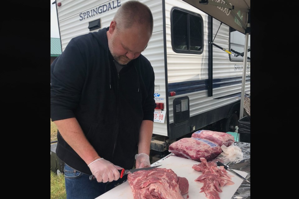 Rusty Johnson, from Port Moody, B.C., prepares meat for the grill during last weekend’s Didsbury Lion’s Club charity Kansas City Barbeque Society (KCBS) barbecue contest. 