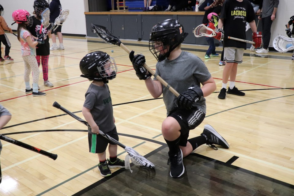 A tiny young aspiring lacrosse player looks up to an older boy during a break in action during the Innisfail Minor Lacrosse Association’s annual Try-It Night on Jan. 15. Johnnie Bachusky/MVP Staff