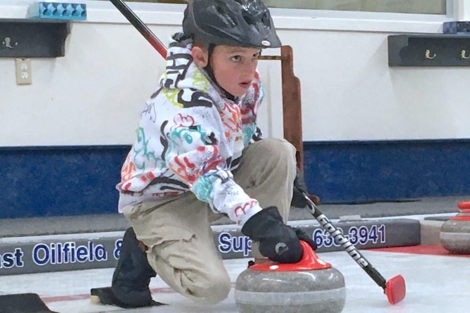 Beau Gleeson was among the numerous people who came out to the Sundre Curling Club’s rink on Saturday, Oct. 26 just one day after the ice’s surface was officially prepared to participate in a learn to curl clinic, which provided those who were interested either an opportunity to refresh their skills or even get acquainted with the sport for the first time. Gleeson was among those learning to play and got a chance to pick up some pointers from longtime club member Bev Konschuh, who is the director of the junior curling program. 
Simon Ducatel/MVP Staff