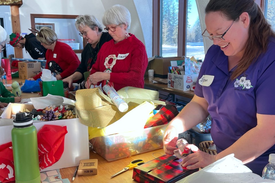 Children had an opportunity to peruse with help from some elves a huge assortment of donated items to find gifts for their family that were then carefully wrapped up by volunteers who had their hands full on Saturday, Dec. 14 during the Magic of Christmas Sale.
Simon Ducatel/MVP Staff