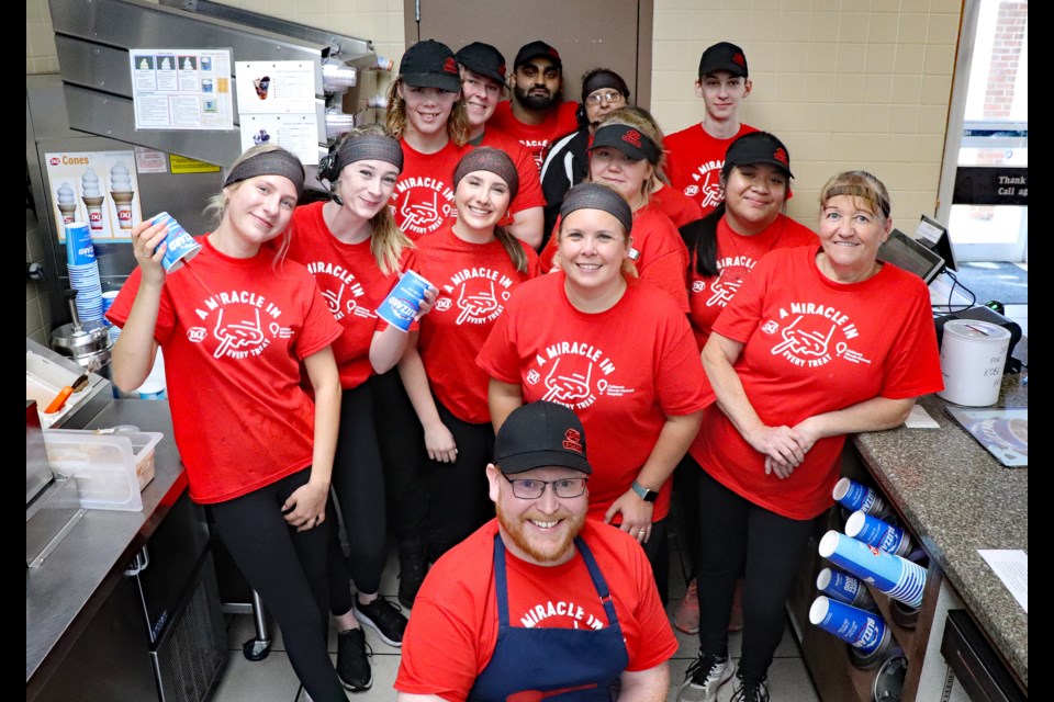 Brett Kemball, manager of Innisfail’s Dairy Queen, front, enthusiastically leads his team for a group smile on the annual Miracle Treat Day on Aug. 10.
Johnnie Bachusky/MVP Staff