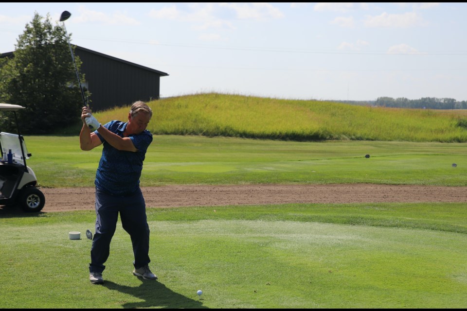 Ken Weseen tees off on the 10th hole during the Sim’s Furniture Mixed Open, held Aug. 11 at the Olds Golf Club.
Doug Collie/MVP Staff