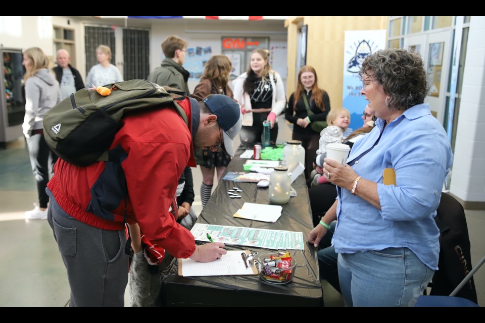 Supporters of the Night Walk for Narcolepsy sign up in the Holy Trinity Catholic School lobby.
Doug Collie/MVP Staff