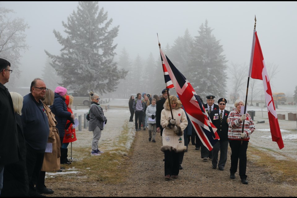 Participants watch as the colours are marched in to start the ceremony.
Doug Collie/MVP Staff