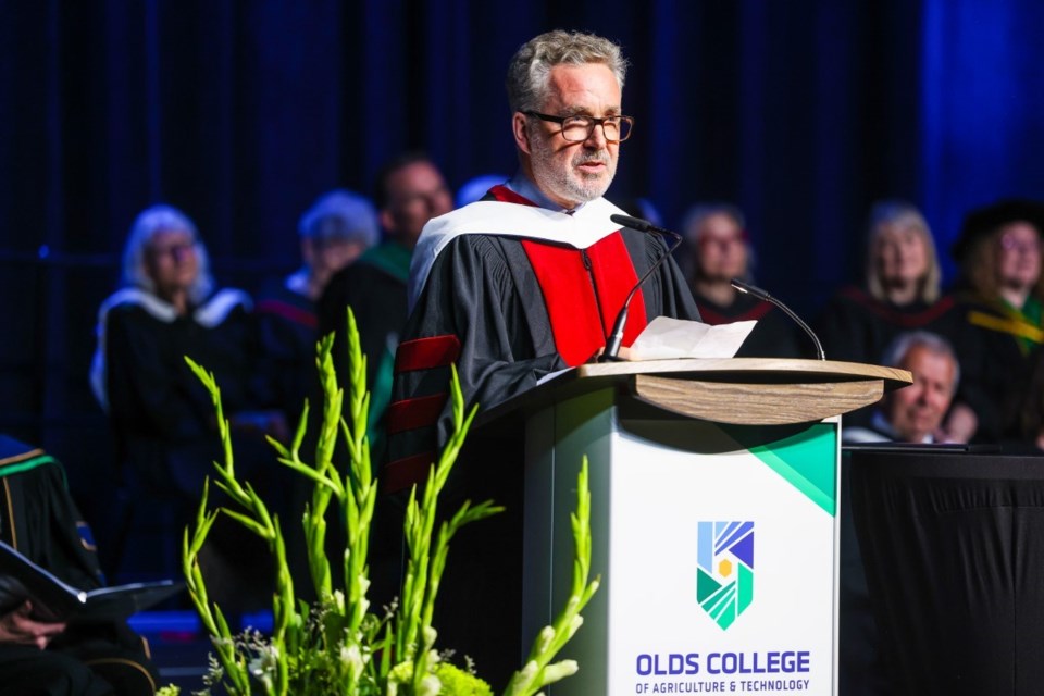 Olds College 2023 honorary degree recipient Jay Cross of the University of Calgary takes to the podium.