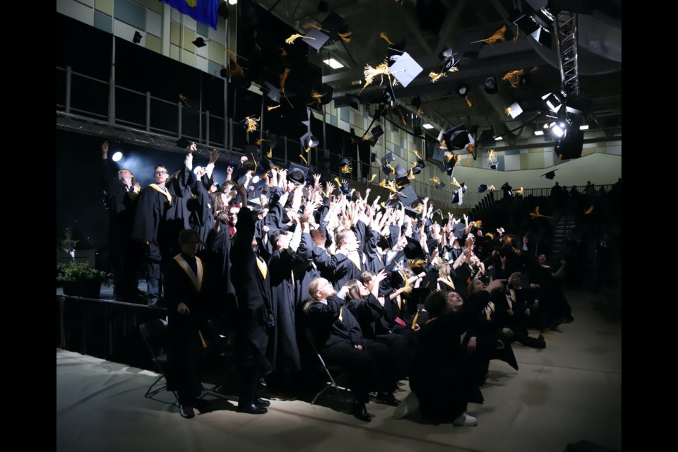 Following tradition, members of the 2024 École Olds High School graduating class toss their caps in the air at the end of the cap and gown ceremony on May 24. Doug Collie/MVP Staff