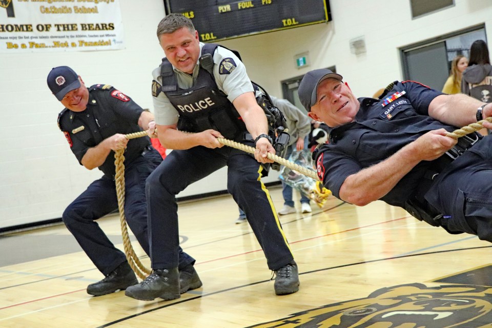 Inisfail's finest were at the 10th annual Penny Carnival doing their best to give it all with tug of war competition in the gym. From let to right is Mike Thomson, assistant fire chief of the Innisfail Fire Department; Innisfail RCMP Const. Craig Nelson, the detachment's community schools resource officer and Innisfail fire chief Gary Leith. Johnnie Bachusky/MVP Staff