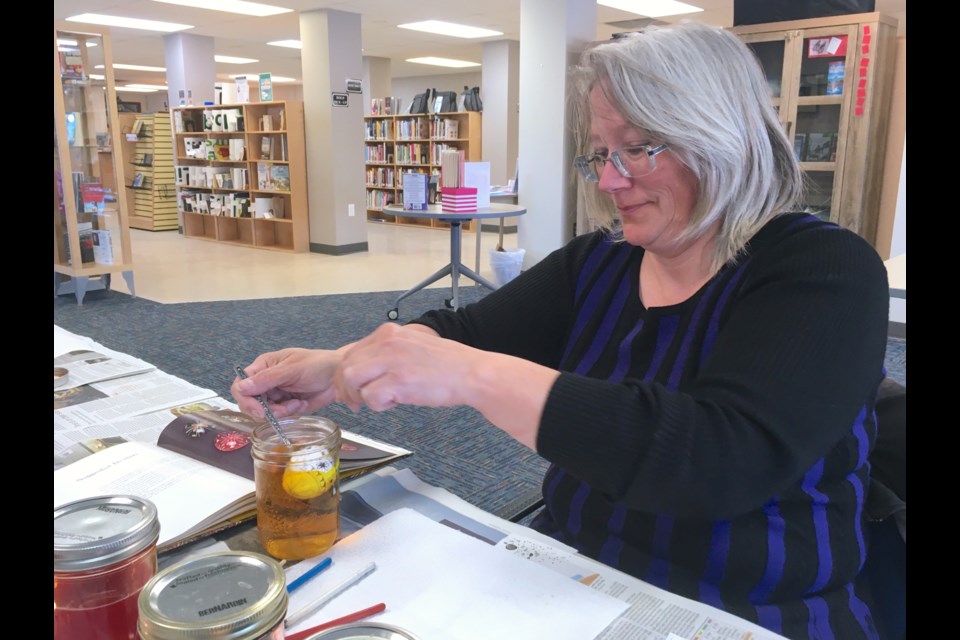 Darlene Turner dips her egg into a jar of yellow paint – a colour that in pysanky art represents light and happiness – during the annual workshop hosted on March 22 at the Sundre Municipal Library under instructor Karen Tubb. 
Simon Ducatel/MVP Staff