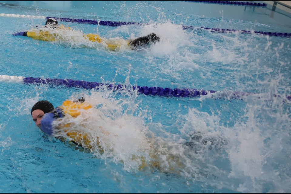 Participants swam relays in builky rescue suits that really splashed up the water.
Doug Collie/MVP Staff