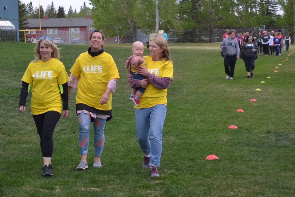 Cancer survivors  Lisa Ormann, Trudi Saby and Louan Statchuk take the first couple of laps during the Relay For Life cancer fundraiser held June 2 from 8 p.m. to 12 midnight at the soccer field just east of École Olds High School. It was believed to be the first Relay For Life since about 2014. 