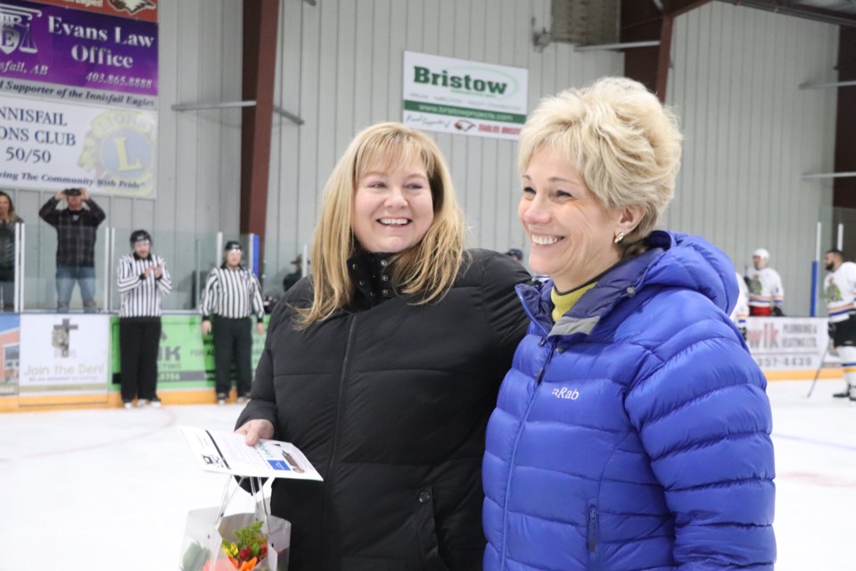 Rhonda Turnquist, one of the lead organizers of the 1st Annual Battle of the Badges Charity Hockey Game on Jan. 6 (left), is all smiles with Innisfail mayor Jean Barclay after being presented with a bouquet of flowers at the successful event. Johnnie Bachusky/MVP Staff