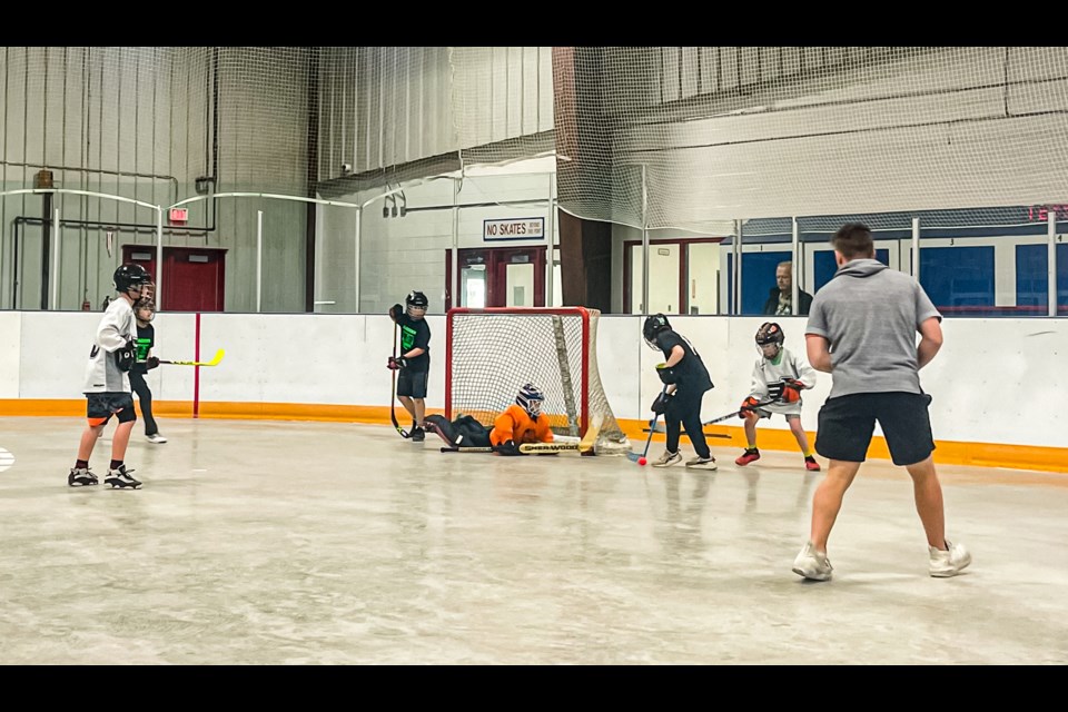 Intense action around the net during a kids' game at the 26th Annual Spring Fever Road Hockey Tournament on April 22 at the Innisfail Twin Arena. This year there were nine kids' teams entered, nearly double the number from last year. Photo by Candice Hughes