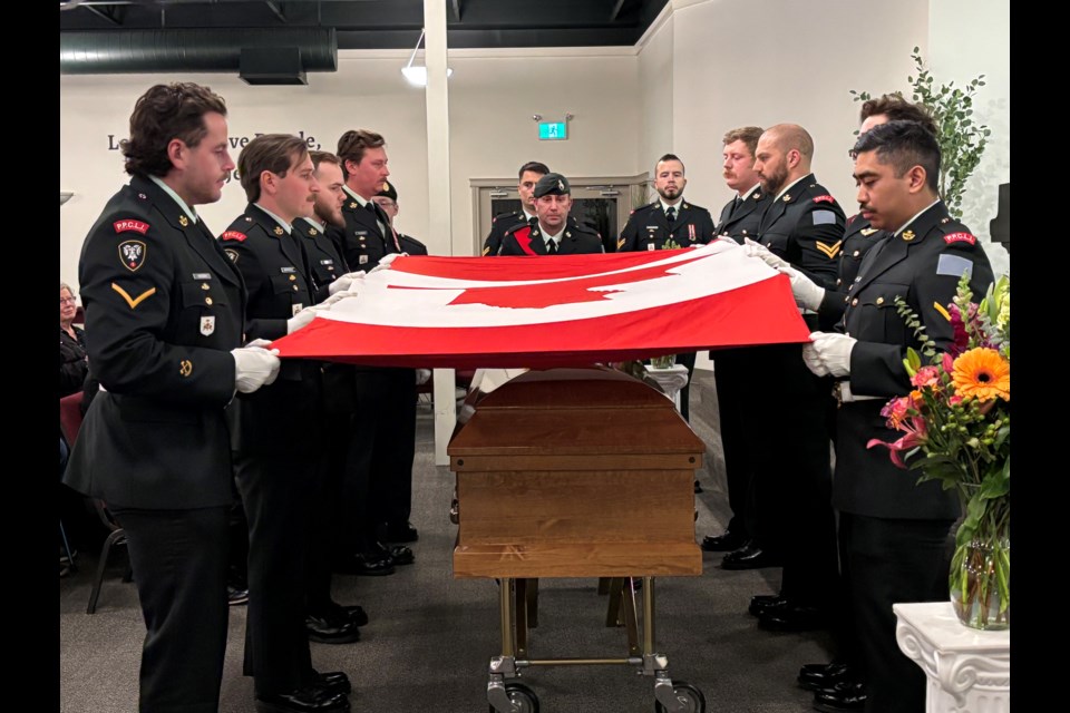 The 11-member Honour Guard from CFB Edmonton’s 3rd Battalion Princess Patricia's Canadian Light Infantry carefully lifts the Canadian flag off the casket of Korean War veteran Russ Sutherland before it was folded and handed to Sutherland's widow Patty. Johnnie Bachusky/MVP Staff