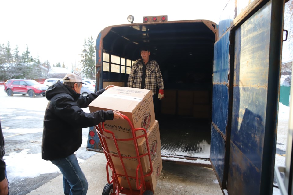 Jerry Prescott brings a load of boxes on a dolly from inside the church to Dallas Christopherson who waits to place them in the trailer. Also helping out were church secretary Shelly Redekopp who tallied the boxes going out as well as Treyton Niemans and Kenton Christopherson who helped load them into the waiting trailer.
Doug Collie/MVP Staff