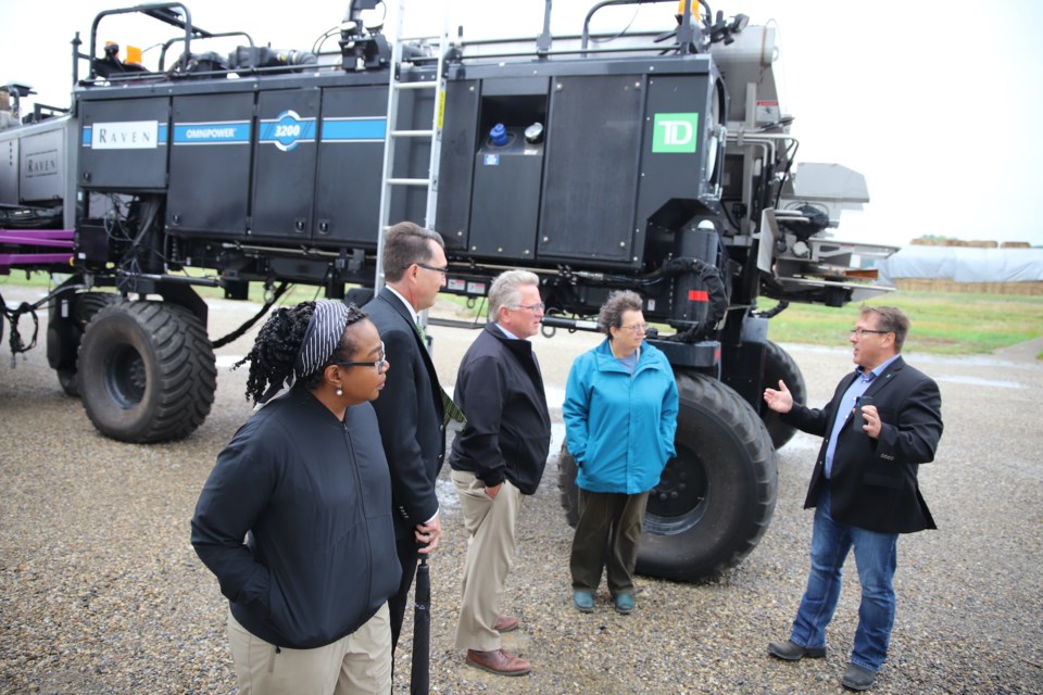 From left, Sen. Sharon Burey, Olds College president Ben Cecil and senators Rob Black and Paula Simons listen as Olds College vice-president of development Todd Ormann discusses modern farming techniques outside the college’s Smart Farm Operations Centre.