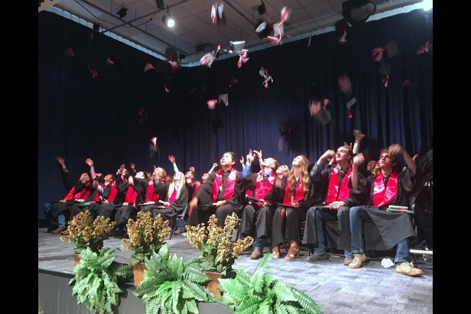 TRADITIONAL MORTARBOARD TOSS — After each individually walking across the stage on Wednesday, June 29 to get their diploma from Sundre High School and Sundre Learning Centre principal Scott Saunders, the 58 students who comprised the Class of 2022 celebrated by tossing their mortarboards in the air. 
Simon Ducatel/MVP Staff