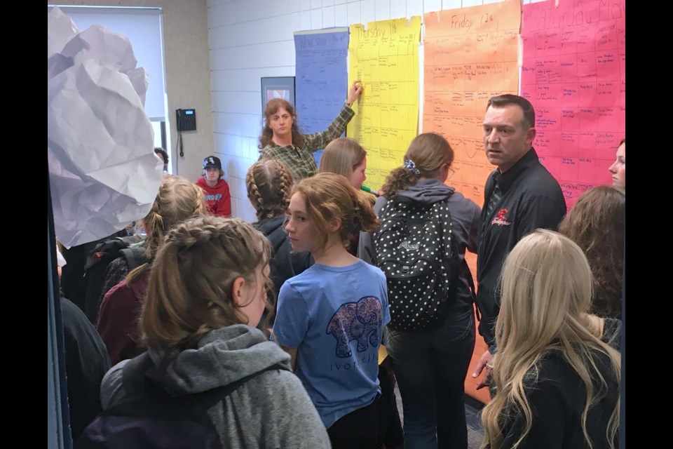 Sundre High School students involved in the annual May Queen fundraising initiative for the school's student council pack into a room after class on the afternoon of May 11 that is being used as the program's de facto command centre where the jobs they've been hired to do in and around the community are broken down and scheduled. 
Simon Ducatel/MVP Staff