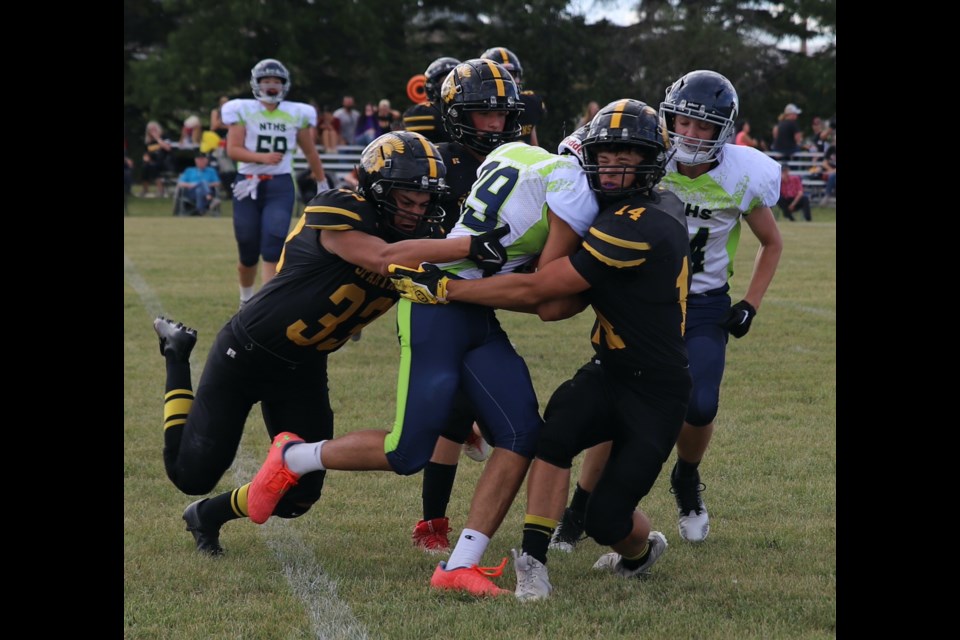 École Olds Spartans Chase Guhl (33) and Zachary Vollmin (14) combine to bring down a North Trail Nighthawk player Aug. 30 at Normie Kwong Park in Olds.
Doug Collie/MVP Staff