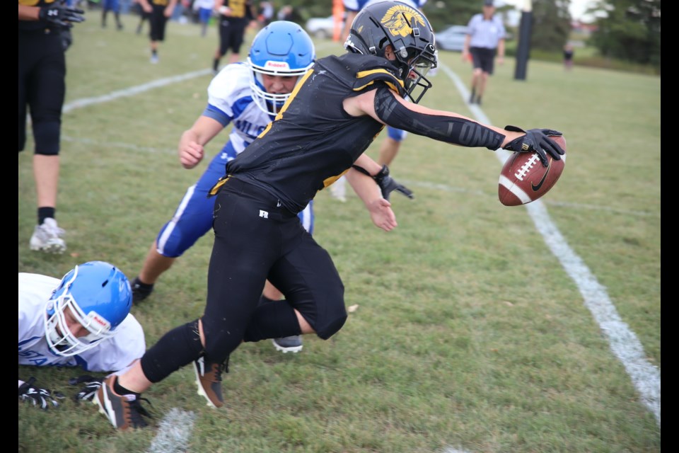 Radek Heppner of the Spartans lunghes for the endzone as a couple of Highwood Mustang players fail to corral him.
Doug Collie/MVP Staff