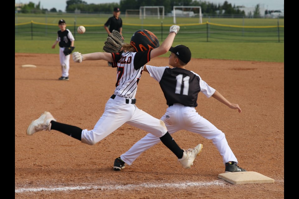 Miller McDonald (17) of the U11 Olds Spitfires, beats the throw to first base during the third annual Spitfires Summer Classic baseball tournament, held during the Canada Day weekend. The U11 Spitfires went on to win their division during the tournament.
Doug Collie/MVP Staff