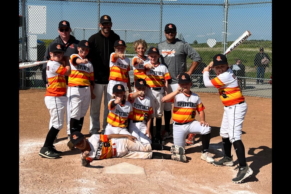 Members of the Olds U11 Spitfires Black team show off their championship rings. 